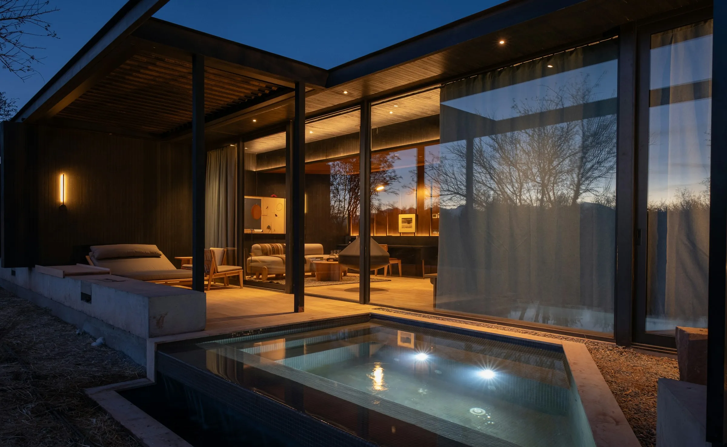 Glass-walled residence at dusk